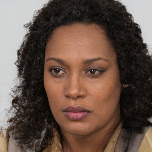 Neutral black adult female with long  brown hair and brown eyes