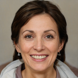 Joyful white adult female with medium  brown hair and brown eyes