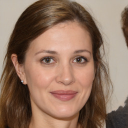 Joyful white adult female with medium  brown hair and brown eyes