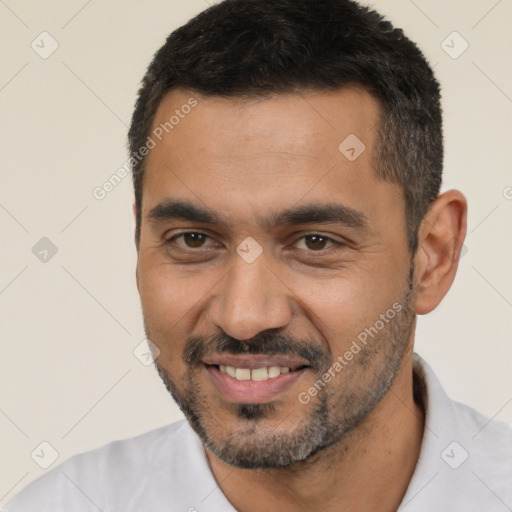 Joyful white young-adult male with short  black hair and brown eyes