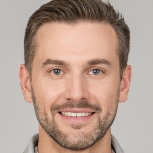 Joyful white young-adult male with short  brown hair and brown eyes