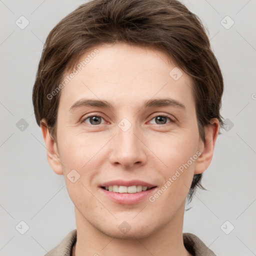 Joyful white young-adult female with short  brown hair and grey eyes