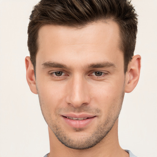 Joyful white young-adult male with short  brown hair and brown eyes