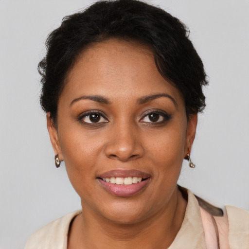 Joyful black young-adult female with short  brown hair and brown eyes