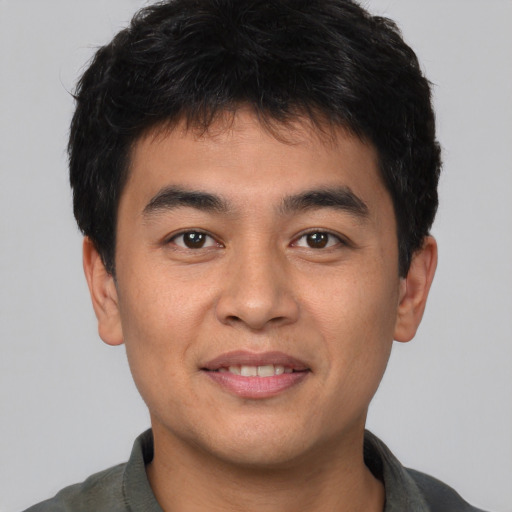 Joyful asian young-adult male with short  brown hair and brown eyes