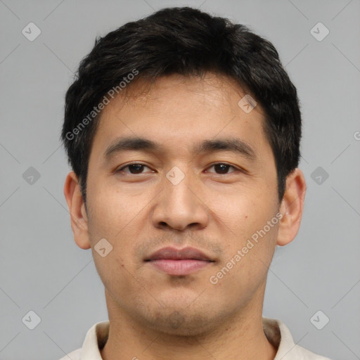 Joyful asian young-adult male with short  black hair and brown eyes