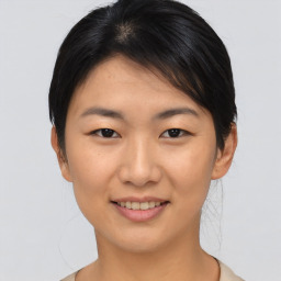 Joyful asian young-adult female with short  brown hair and brown eyes