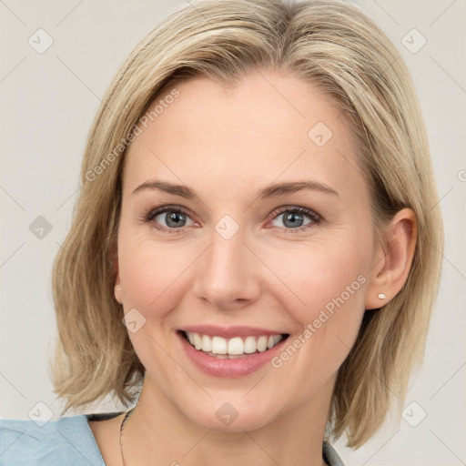 Joyful white young-adult female with medium  brown hair and blue eyes