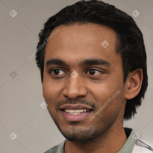 Joyful black young-adult male with short  black hair and brown eyes