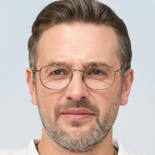 Joyful white middle-aged male with short  brown hair and brown eyes