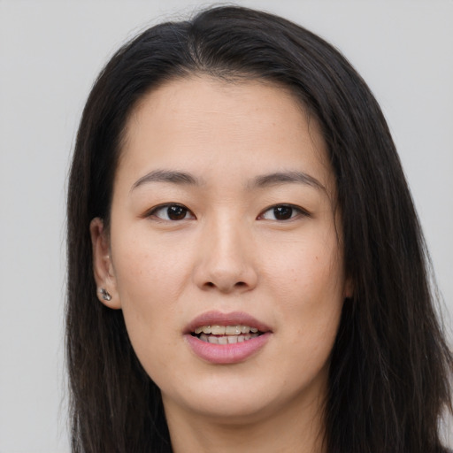 Joyful asian young-adult female with long  brown hair and brown eyes