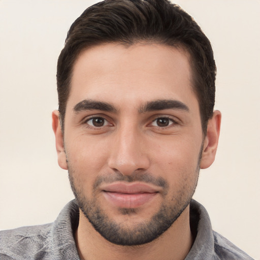 Joyful white young-adult male with short  black hair and brown eyes