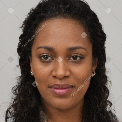 Joyful black young-adult female with long  brown hair and brown eyes