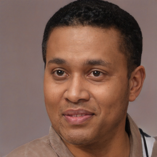 Joyful latino adult male with short  black hair and brown eyes