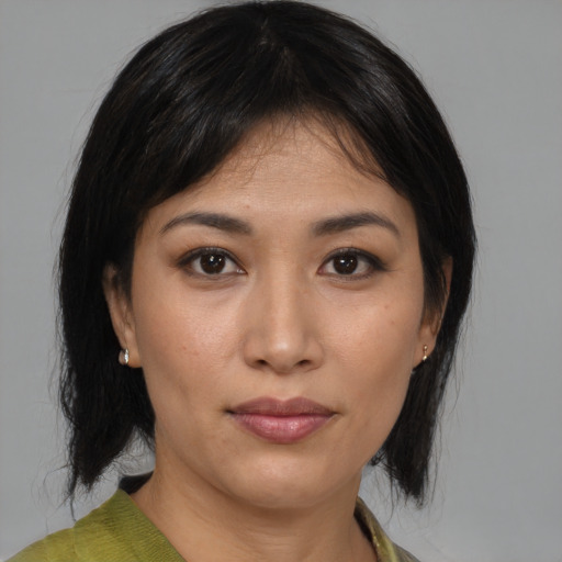 Joyful asian young-adult female with medium  brown hair and brown eyes