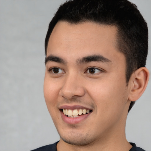 Joyful latino young-adult male with short  brown hair and brown eyes