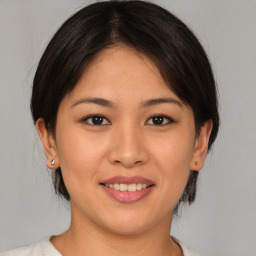 Joyful white young-adult female with medium  brown hair and brown eyes