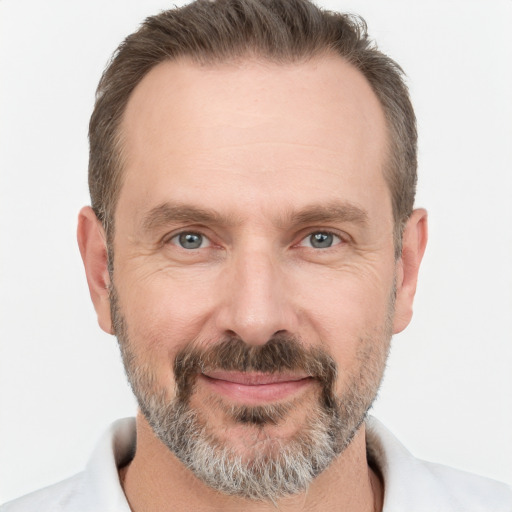 Joyful white adult male with short  brown hair and grey eyes