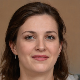 Joyful white adult female with long  brown hair and brown eyes