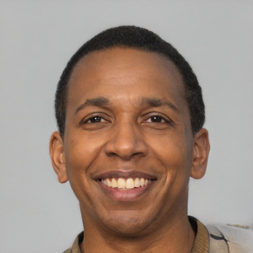 Joyful latino adult male with short  black hair and brown eyes