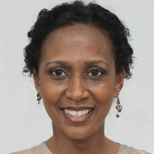 Joyful black adult female with short  brown hair and brown eyes