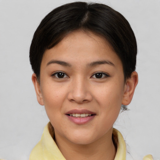 Joyful asian young-adult female with short  brown hair and brown eyes