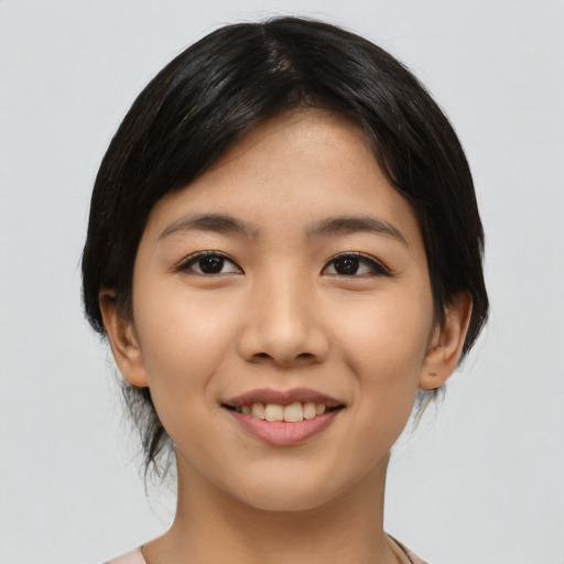 Joyful asian young-adult female with medium  black hair and brown eyes