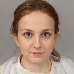 Joyful white young-adult female with medium  brown hair and blue eyes