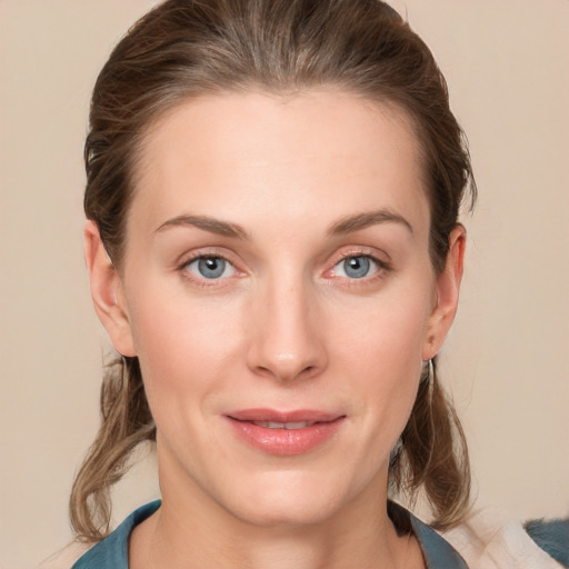 Joyful white young-adult female with medium  brown hair and blue eyes