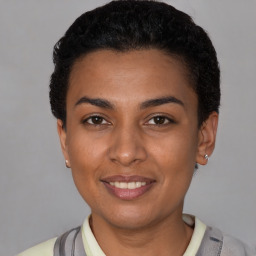 Joyful latino young-adult female with short  black hair and brown eyes