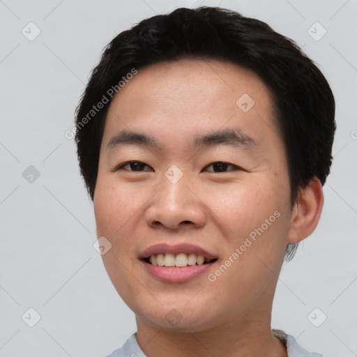 Joyful asian young-adult male with short  black hair and brown eyes