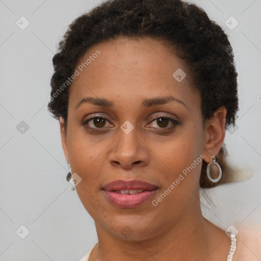 Joyful black adult female with short  brown hair and brown eyes