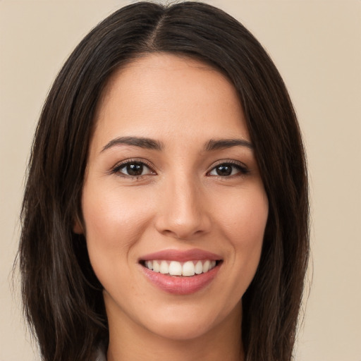 Joyful white young-adult female with long  brown hair and brown eyes