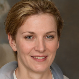 Joyful white adult female with short  brown hair and grey eyes