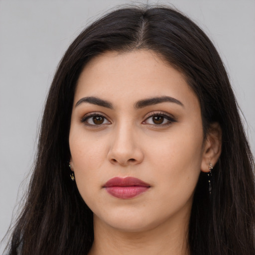 Joyful latino young-adult female with long  brown hair and brown eyes