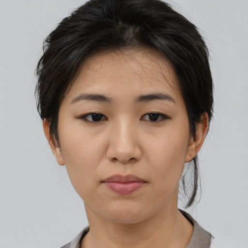 Neutral asian young-adult female with medium  brown hair and brown eyes