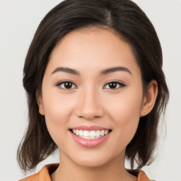 Joyful white young-adult female with medium  brown hair and brown eyes