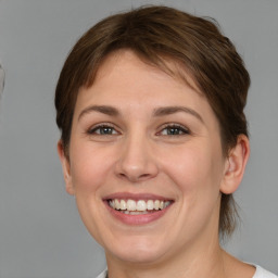 Joyful white young-adult female with short  brown hair and grey eyes