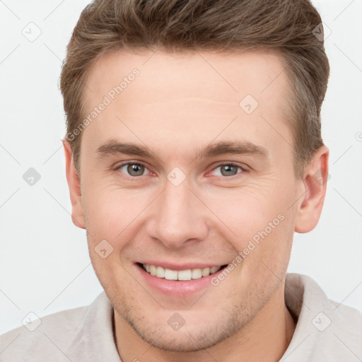 Joyful white young-adult male with short  brown hair and grey eyes