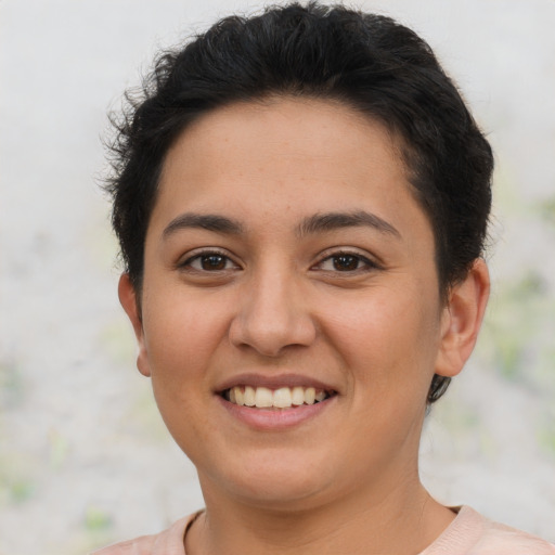 Joyful latino young-adult female with short  brown hair and brown eyes