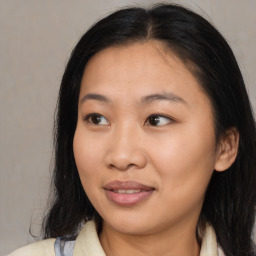 Joyful asian young-adult female with medium  brown hair and brown eyes