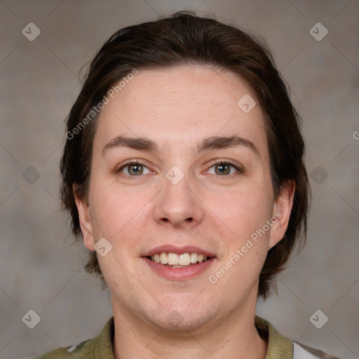 Joyful white adult female with medium  brown hair and grey eyes