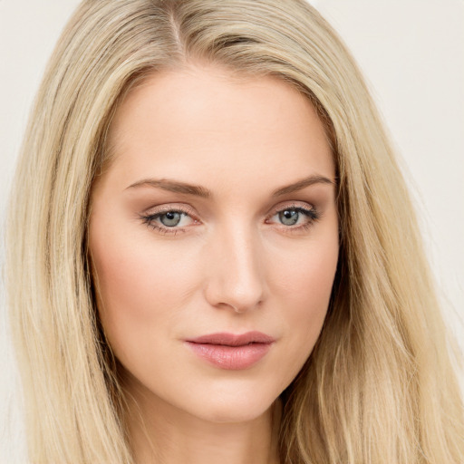 Joyful white young-adult female with long  brown hair and green eyes