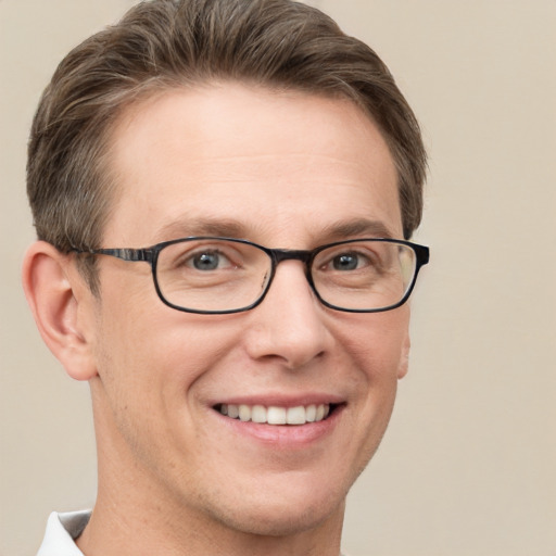 Joyful white adult male with short  brown hair and grey eyes