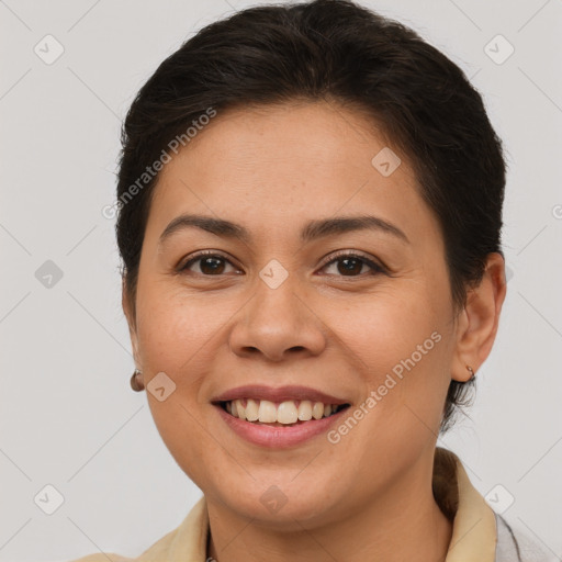 Joyful latino young-adult female with medium  brown hair and brown eyes