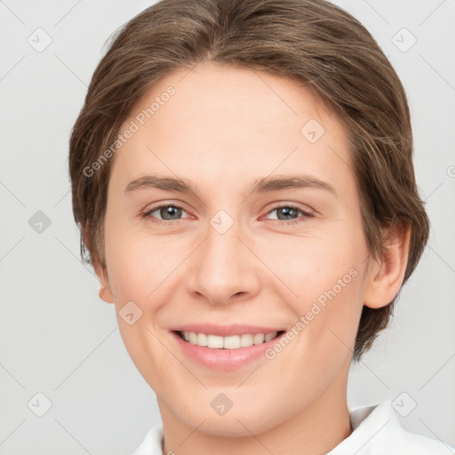 Joyful white young-adult female with medium  brown hair and grey eyes