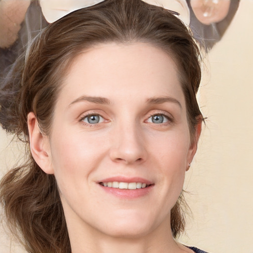 Joyful white young-adult female with medium  brown hair and blue eyes