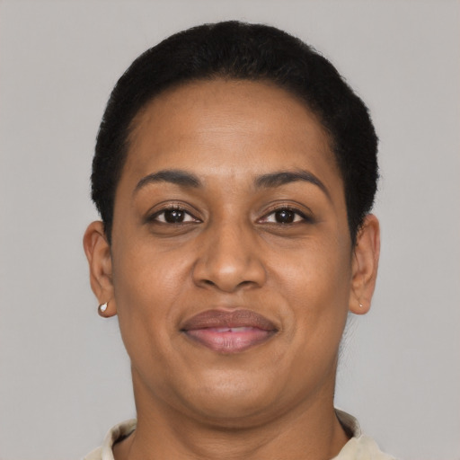 Joyful black adult female with short  brown hair and brown eyes