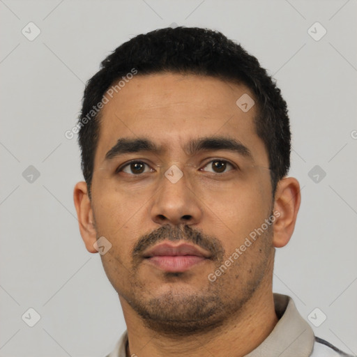 Neutral latino adult male with short  black hair and brown eyes