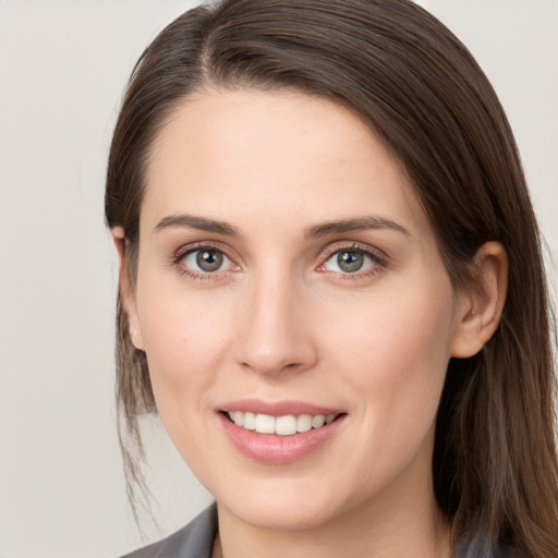 Joyful white young-adult female with medium  brown hair and grey eyes